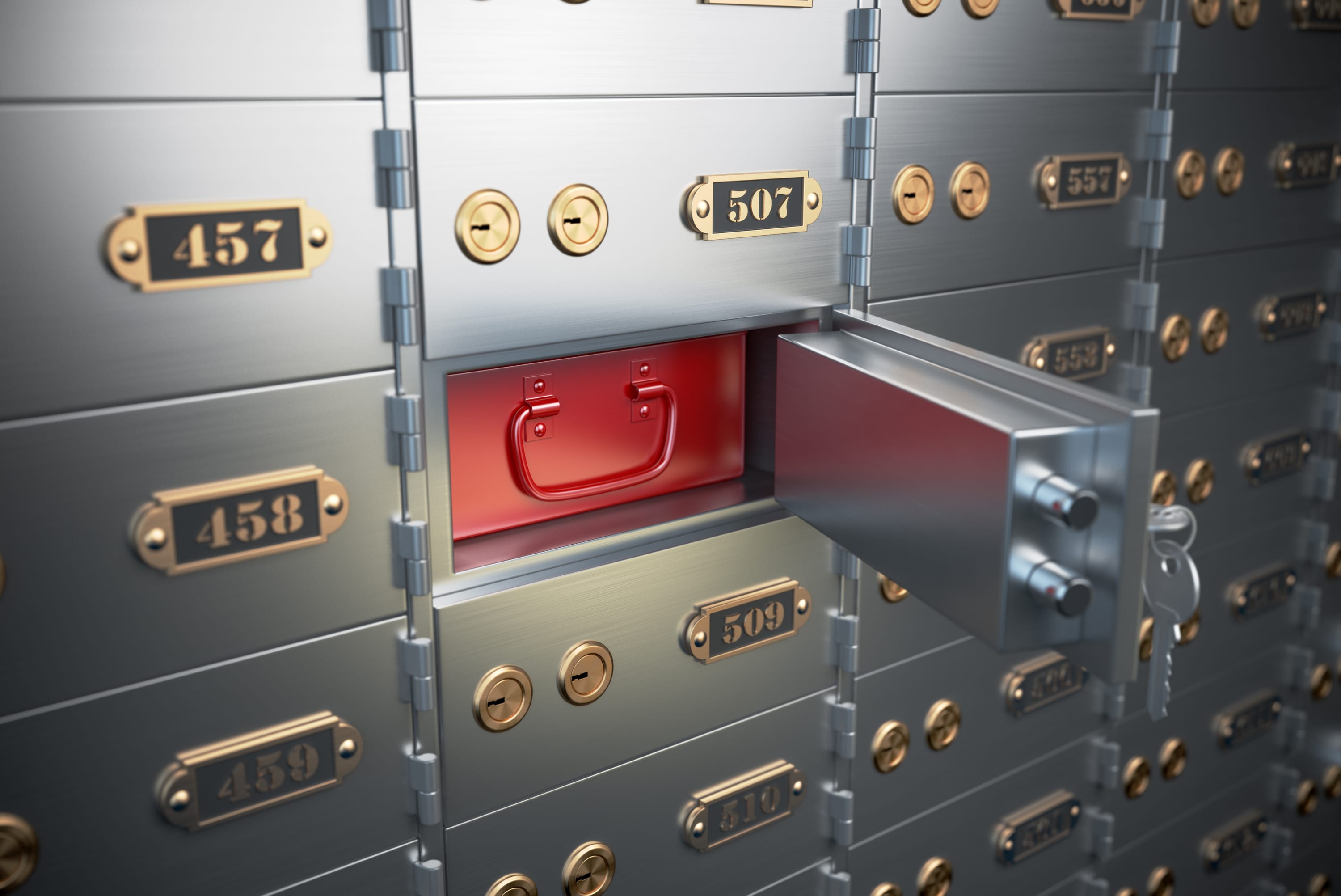 An open safe deposit box with a red case inside.
